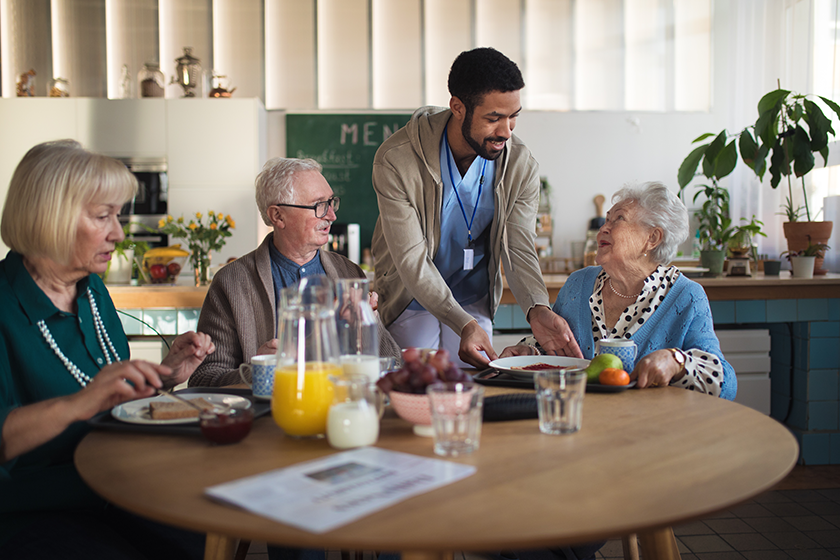 group-of-cheerful-seniors-enjoying-breakfast