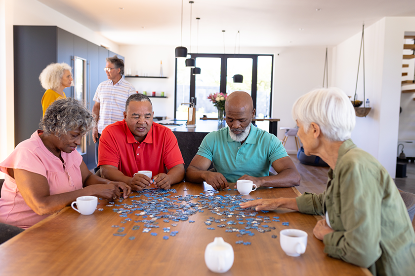 multiracial-senior-friends-solving-jigsaw-puzzle